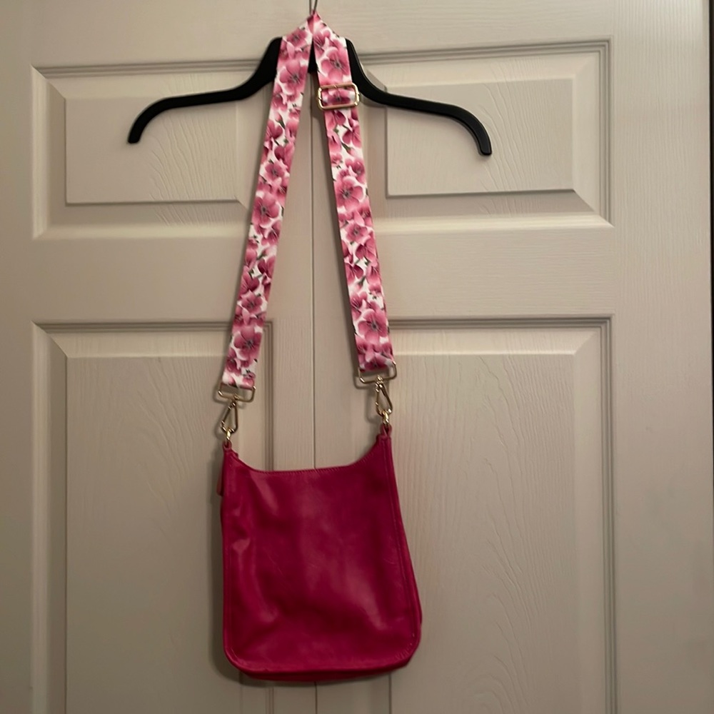 Ahdorned brand crossbody bag with 2 straps.